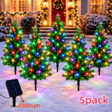 Close view of a single mini Christmas tree solar stake light and its ground spike