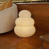 Rice paper lantern table lamp glowing warm light in a bedroom