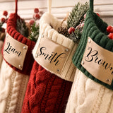 Knit family Christmas stockings on a mantel