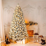 Pre lit white flocked Christmas tree glowing with warm lights