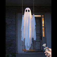 Large lighted ghost Halloween decoration swinging outdoors