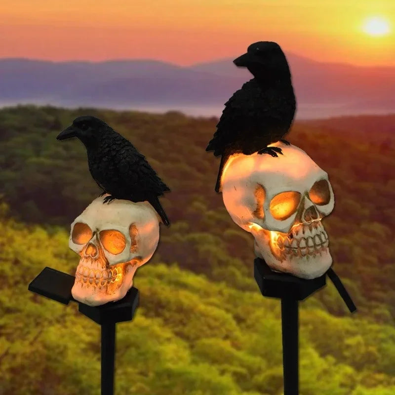 Halloween skeleton head solar light glowing in a garden