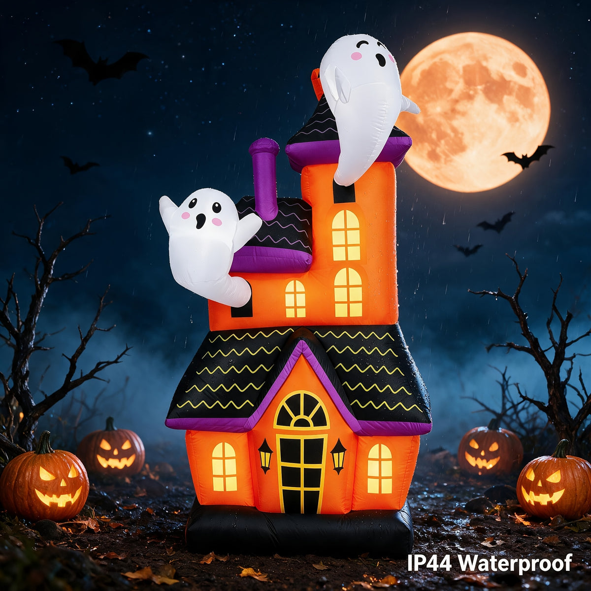 Large inflatable haunted house ghost castle decoration lit up in a yard - view 1