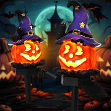Halloween solar light with 3D pumpkin design glowing in a garden