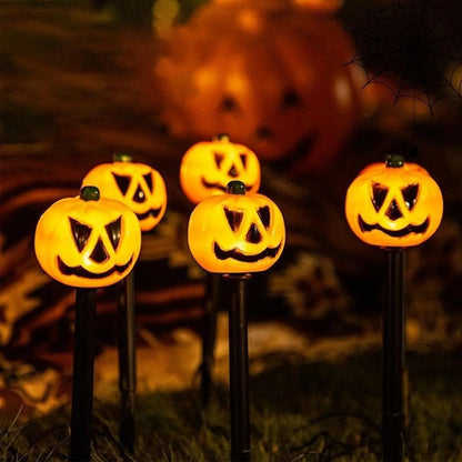 Solar Halloween decor set staked along a garden path