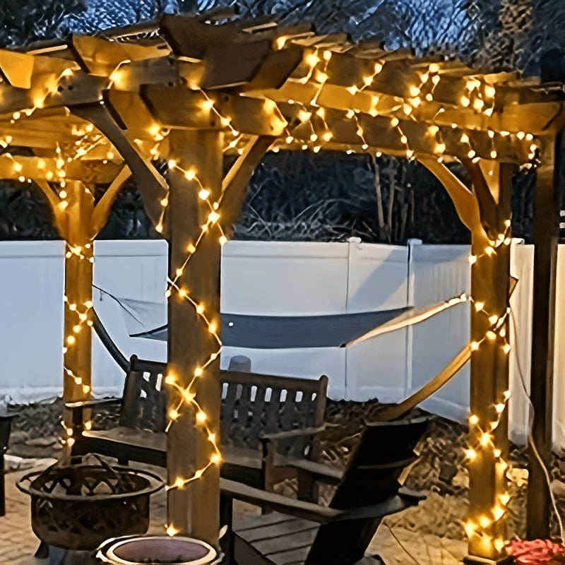 Fairy lights on a hedge outdoors after rain