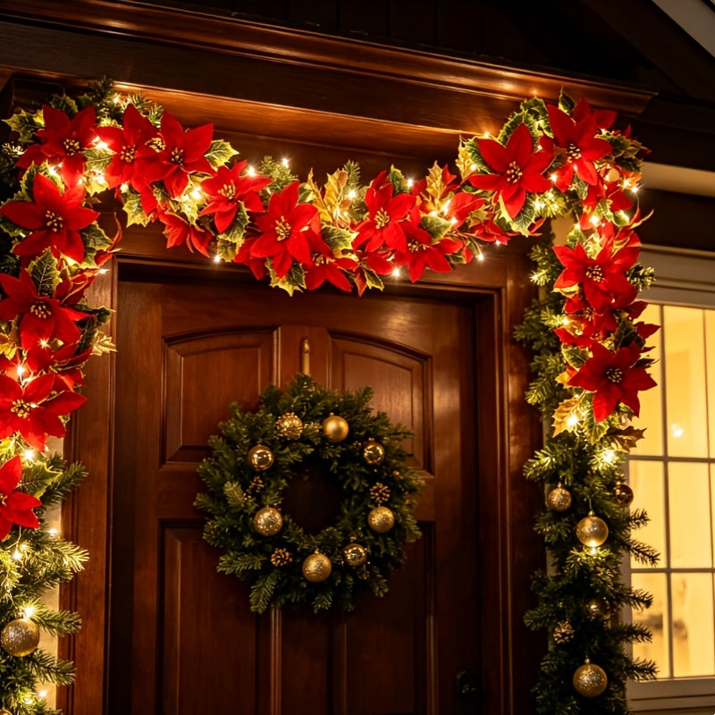 Close view of the red flowers and foliage on the lit garland