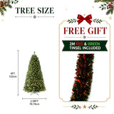 Lush artificial Christmas tree with red and green tinsel
