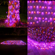 Orange and purple LED solar net lights draped over outdoor bushes for Halloween - view 2