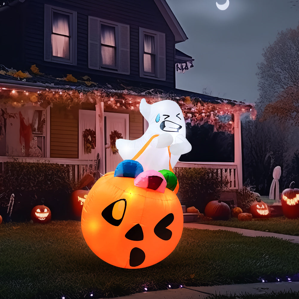 Five foot inflatable pumpkin with candy bag lit on a lawn