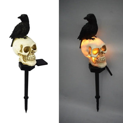 Skeleton head solar light staked along a pathway