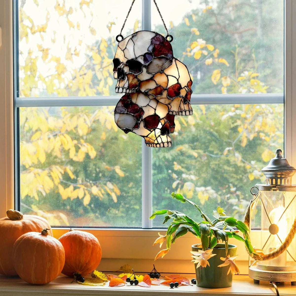 Hanging skeleton head decoration displayed in a window