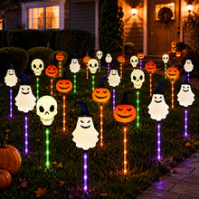 Six solar Halloween garden lights in pumpkin, skull and ghost shapes glowing in a lawn at night