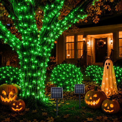 Fairy lights draped along a garden fence at night