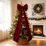 Red bow mounted on a wedding arch with the ribbon tails hanging free