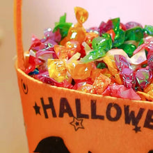 Child holding a Halloween treat bag while trick-or-treating