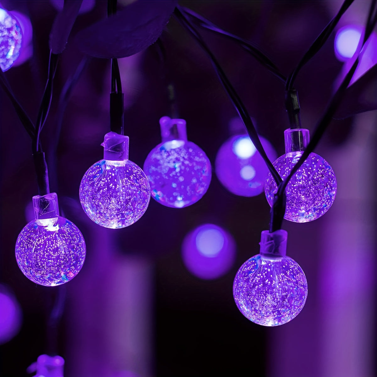 Purple LED solar bubble ball string lights wrapped around an outdoor tree - view 3