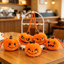 Close-up of embroidered expression on pumpkin plush keychain