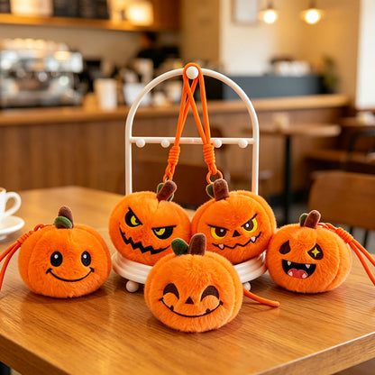 Close-up of embroidered expression on pumpkin plush keychain
