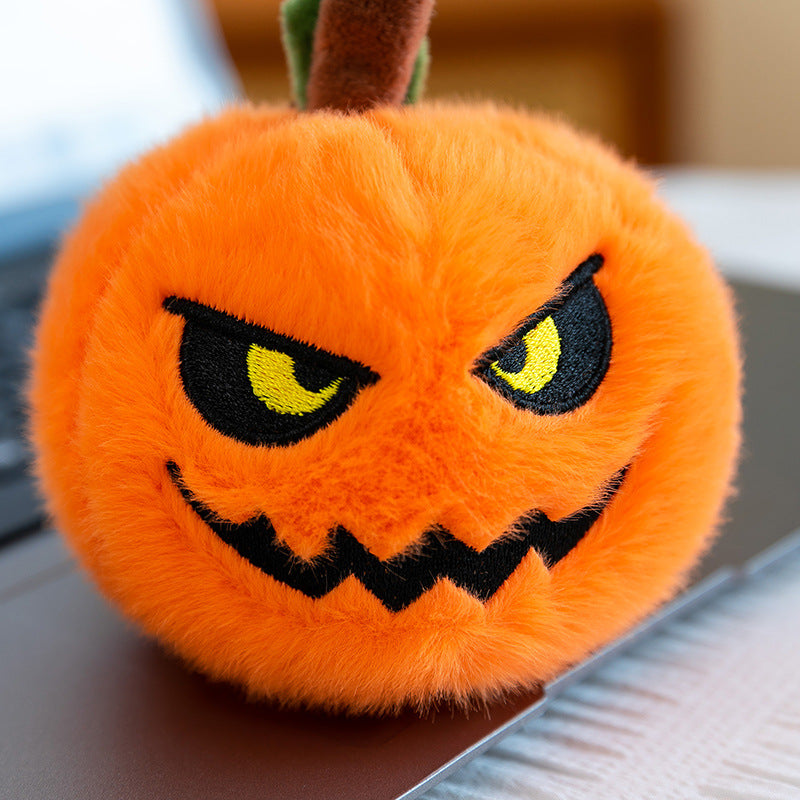 Pumpkin plush keychain attached to a handbag