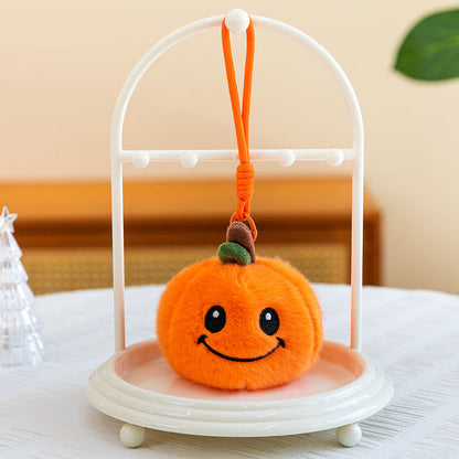 Pumpkin plush keychains in assorted expressions displayed in a row