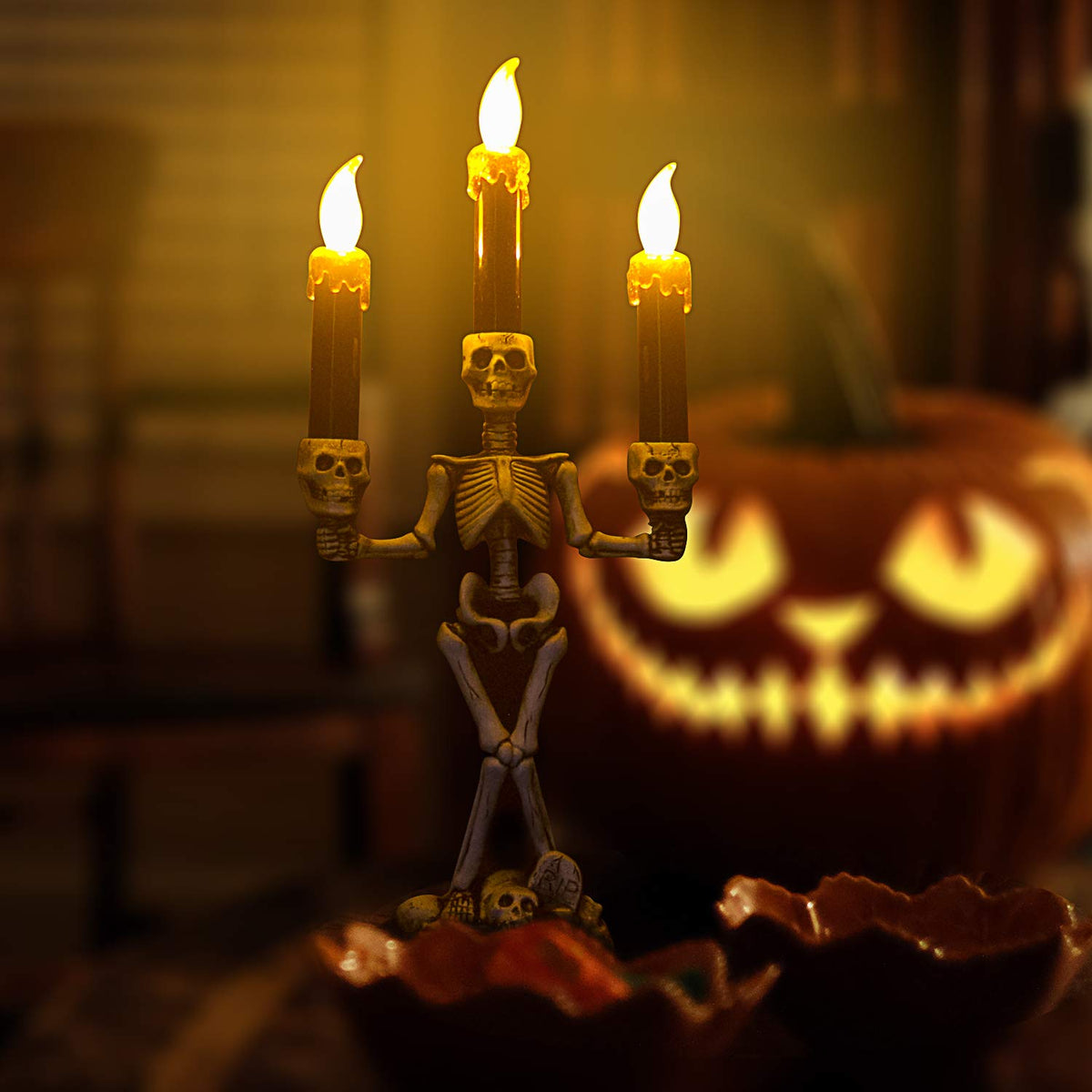 Skeleton-shaped candle holder lit by its built-in LED for a Halloween tabletop