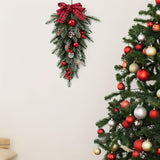 Pine cone and red berry accents on an artificial Christmas swag