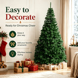 Full green artificial Christmas tree standing unlit on a metal base