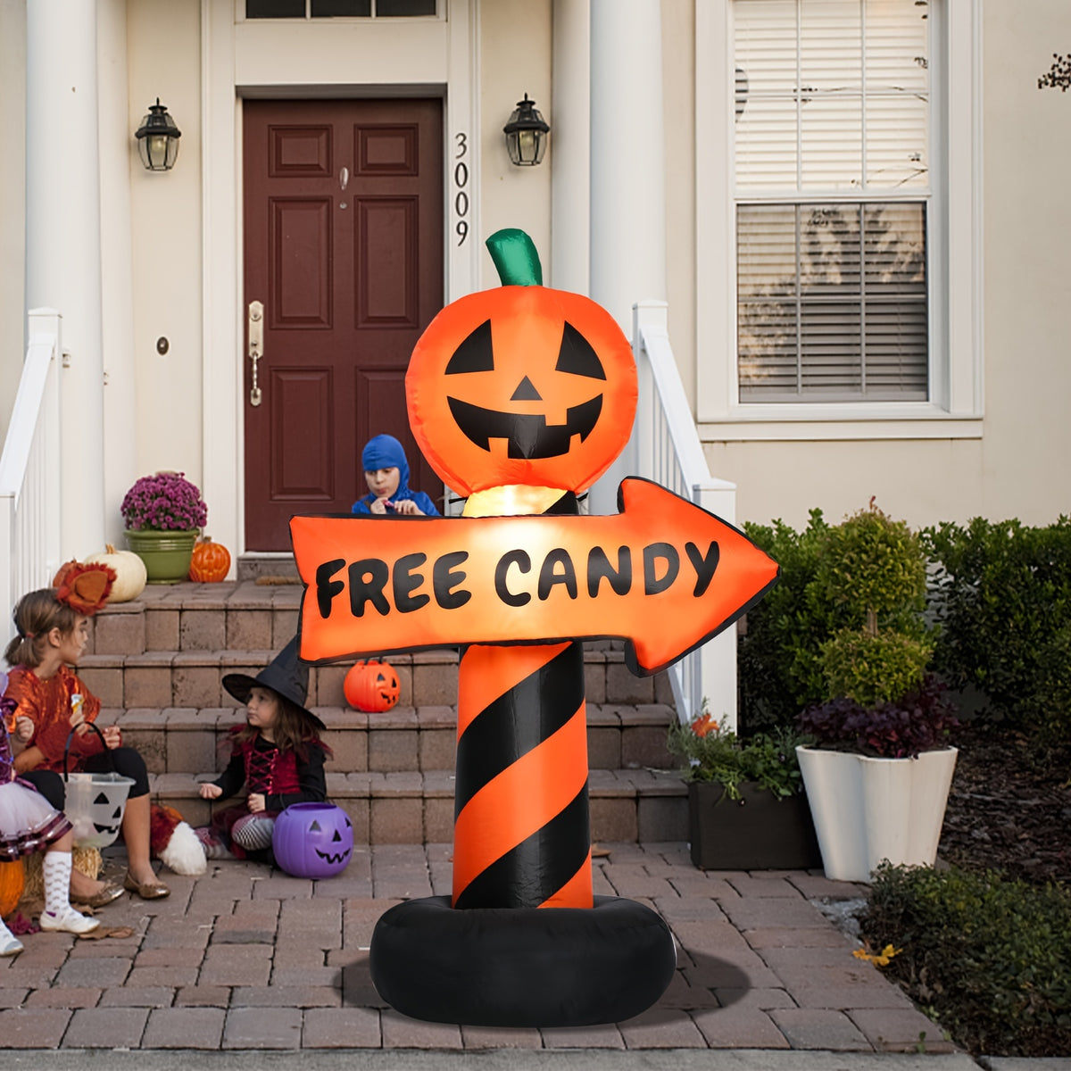 Inflatable pumpkin road sign placed at the edge of a driveway