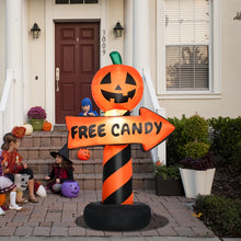 Inflatable pumpkin road sign placed at the edge of a driveway