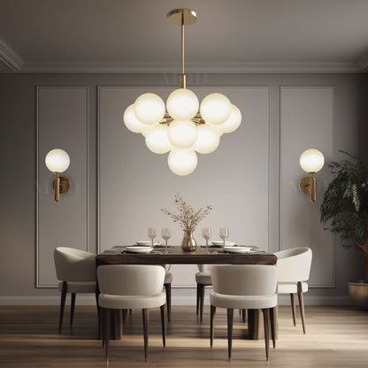 Solenne Pendant, close-up of the brushed gold frame and globe shades
