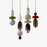 Candied Glass Pendant Light with multicolor tinted glass jar shades over a dining table