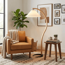 Close-up of the Caprani floor lamp's beechwood stem and metal base