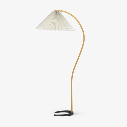 Caprani beechwood floor lamp with white linen shade in a living room