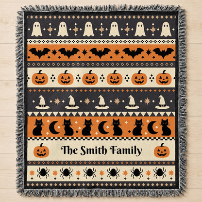 Close-up of the woven Halloween blanket's ghost and pumpkin motif