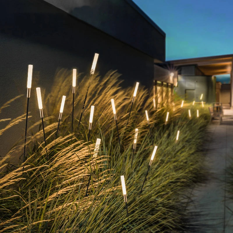Reed-shaped acrylic landscape light installed along a garden path