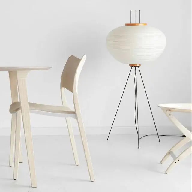 Rice paper ball floor lamp glowing in a bedroom