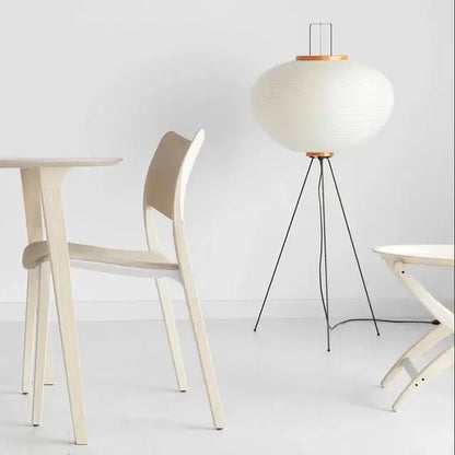 Rice paper ball floor lamp glowing in a bedroom
