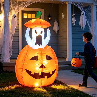 Illuminated jack-o'-lantern inflatable with rising ghost figure displayed on a porch at night