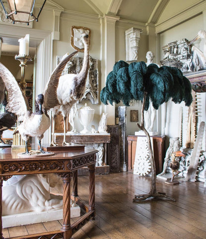 Ostrich feather floor lamp shown in a bedroom styling setting