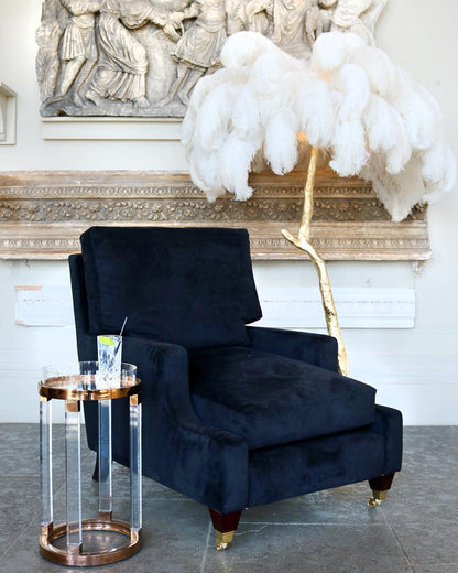 Ostrich feather floor lamp shown in a bedroom styling setting