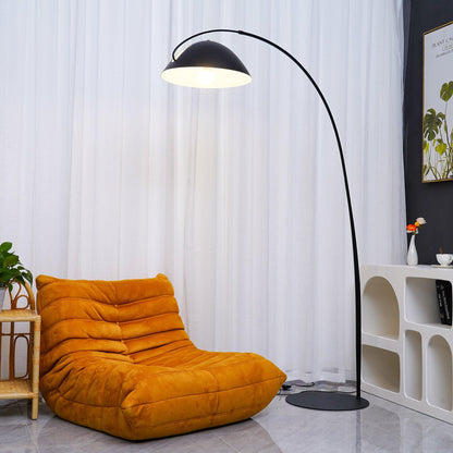 Verse arc floor lamp large size shown next to a sofa for scale