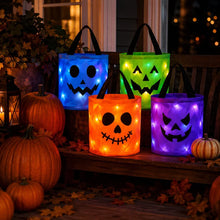 Four LED light-up Halloween trick-or-treat buckets in purple, green, blue, and orange with jack-o-lantern faces