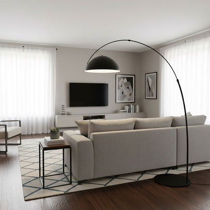 Verse arc floor lamp beside a reading chair, shade angled downward