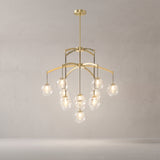 Adelina brushed gold globe chandelier on a warm light grey studio background