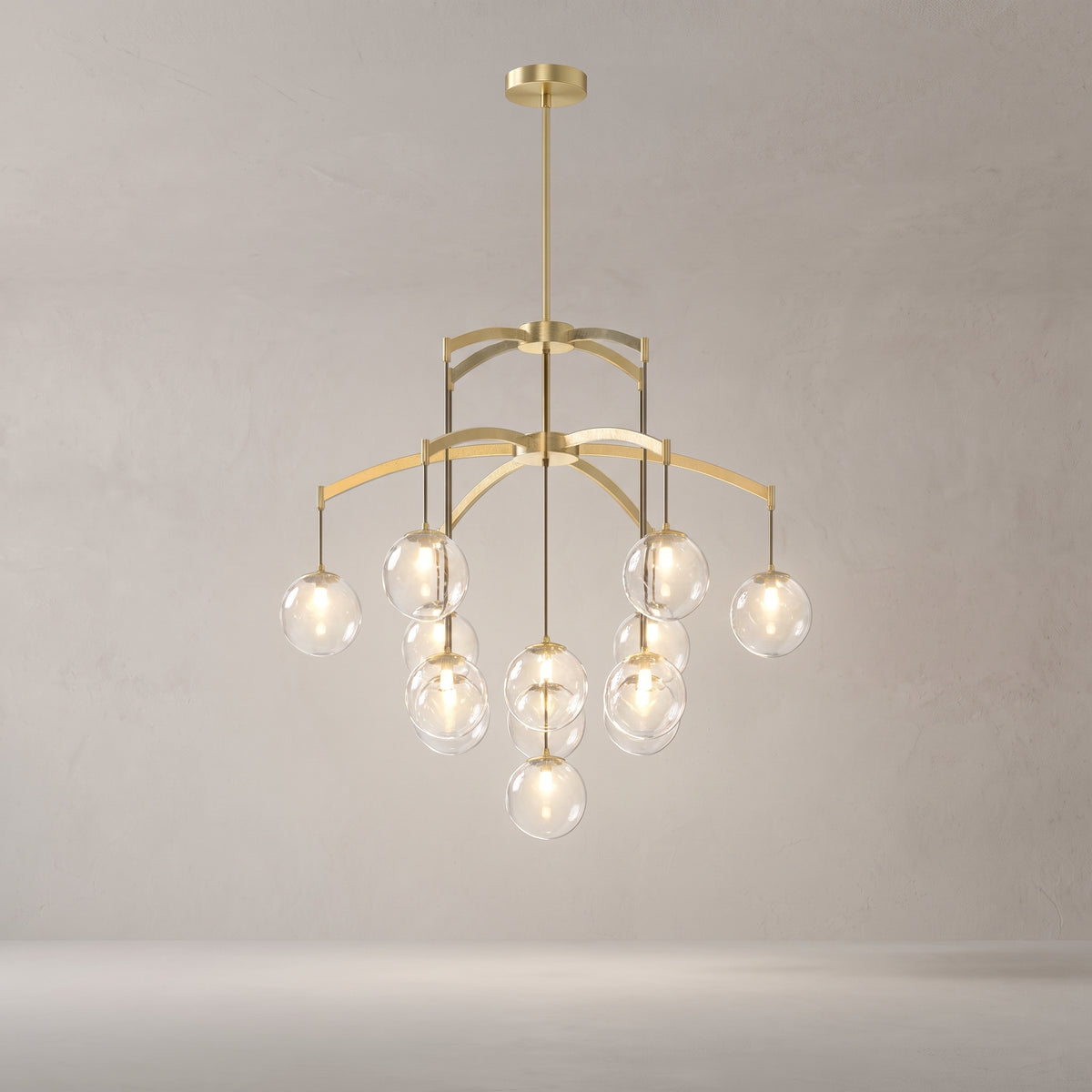 Adelina brushed gold globe chandelier on a warm light grey studio background