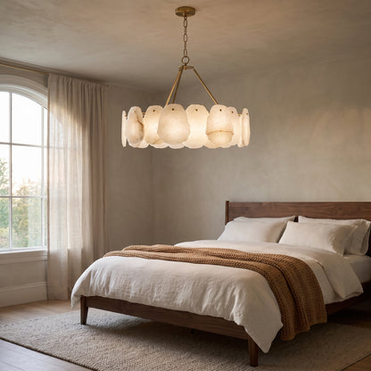 Alabaster chandelier with a brushed gold brass frame in a bedroom