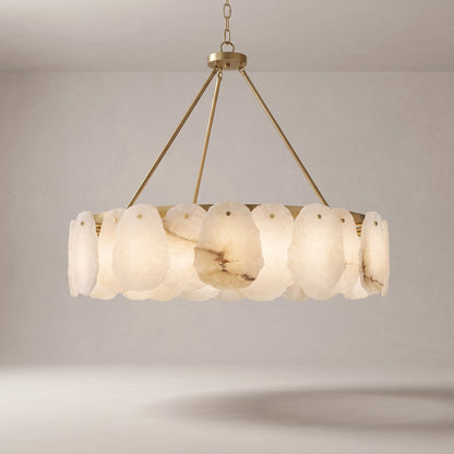 Alabaster chandelier with a brushed gold brass frame on a grey studio background