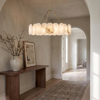 Alabaster chandelier with a brushed gold brass frame in an entry hall