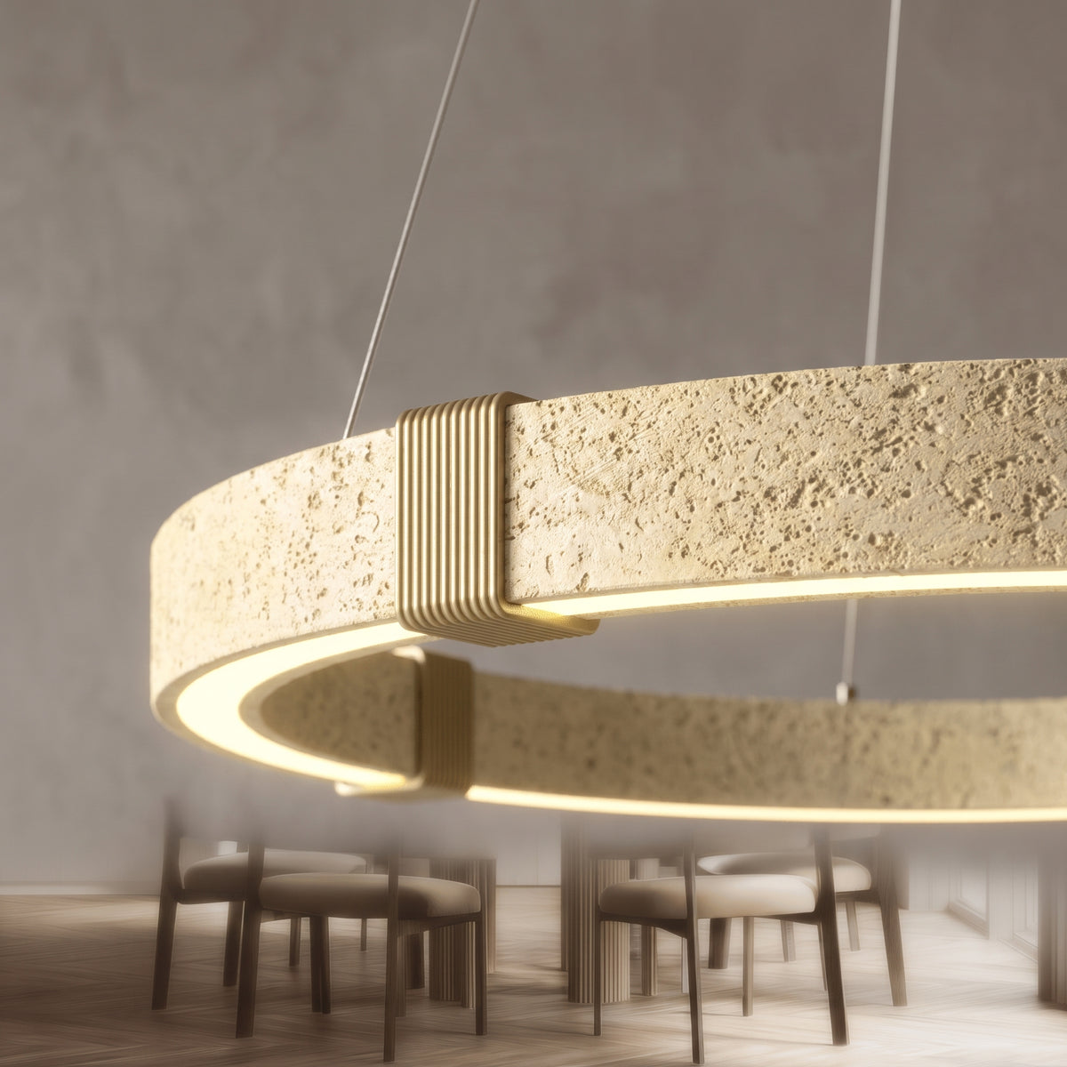 Close-up of the Torvi chandelier's travertine texture and brass clamp